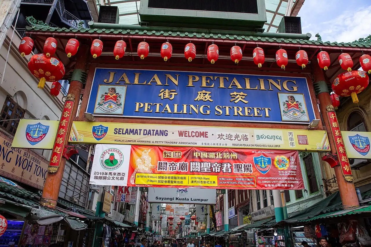 Colorful red lanterns adorn the main archway welcoming visitors to Kuala Lumpur's bustling Chinatown Petaling Street market