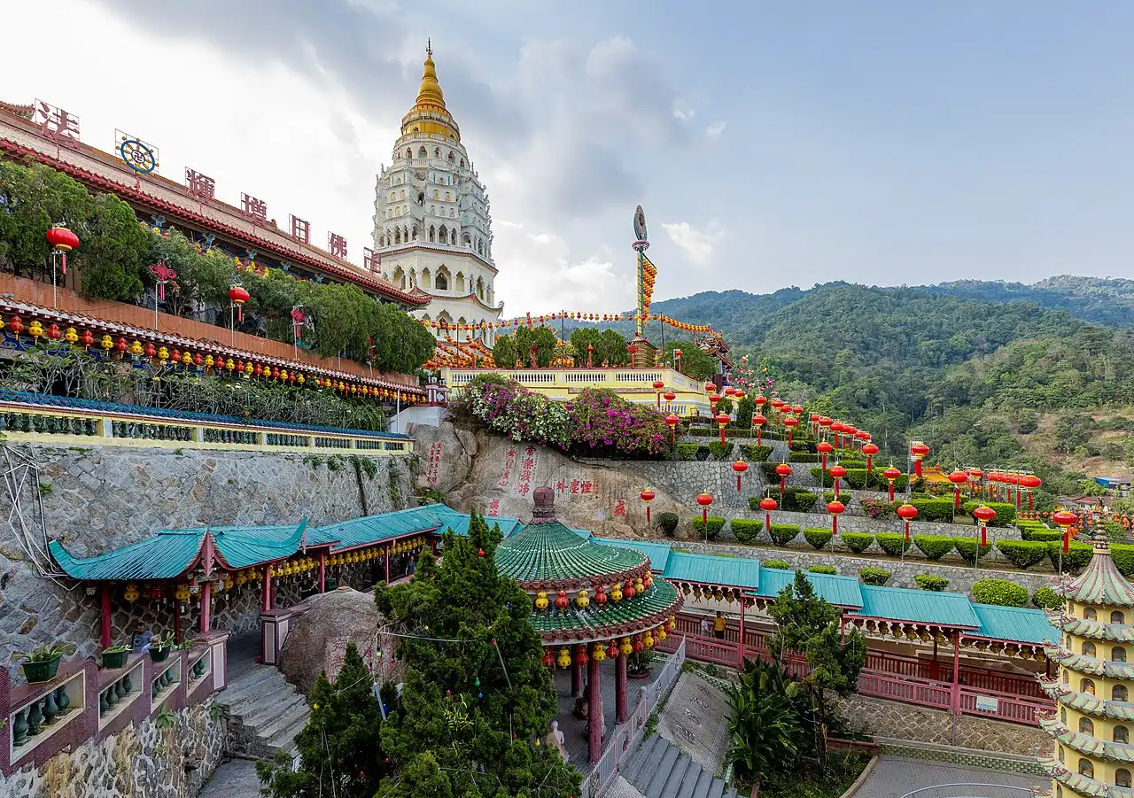 Panoramic view of Kek Lok Si Temple in Penang, Malaysia, with its pagoda, colorful lanterns, and terraced gardens