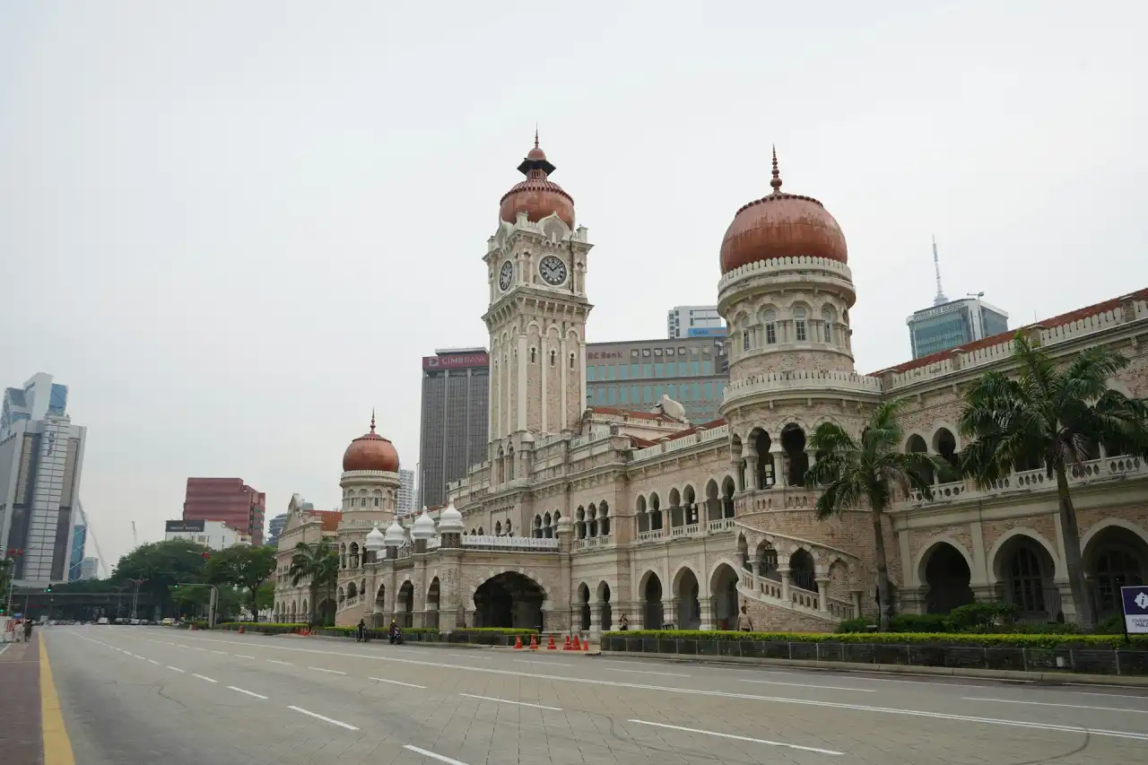 Majestic Sultan Abdul Samad Building and clock tower at Merdeka Square, Kuala Lumpur, with modern city buildings behind